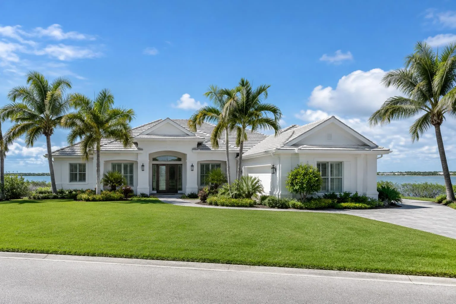 Bright Florida home with palm trees under a blue sky